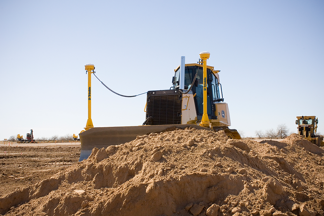 Dozer using site positioning solutions Trimble techonology on a construction site.